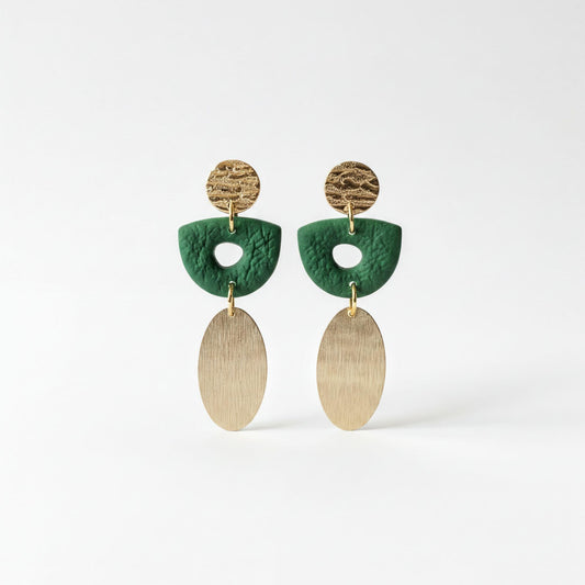 A pair of earrings with green and gold elements, including oval-shaped charms and a metallic ring.