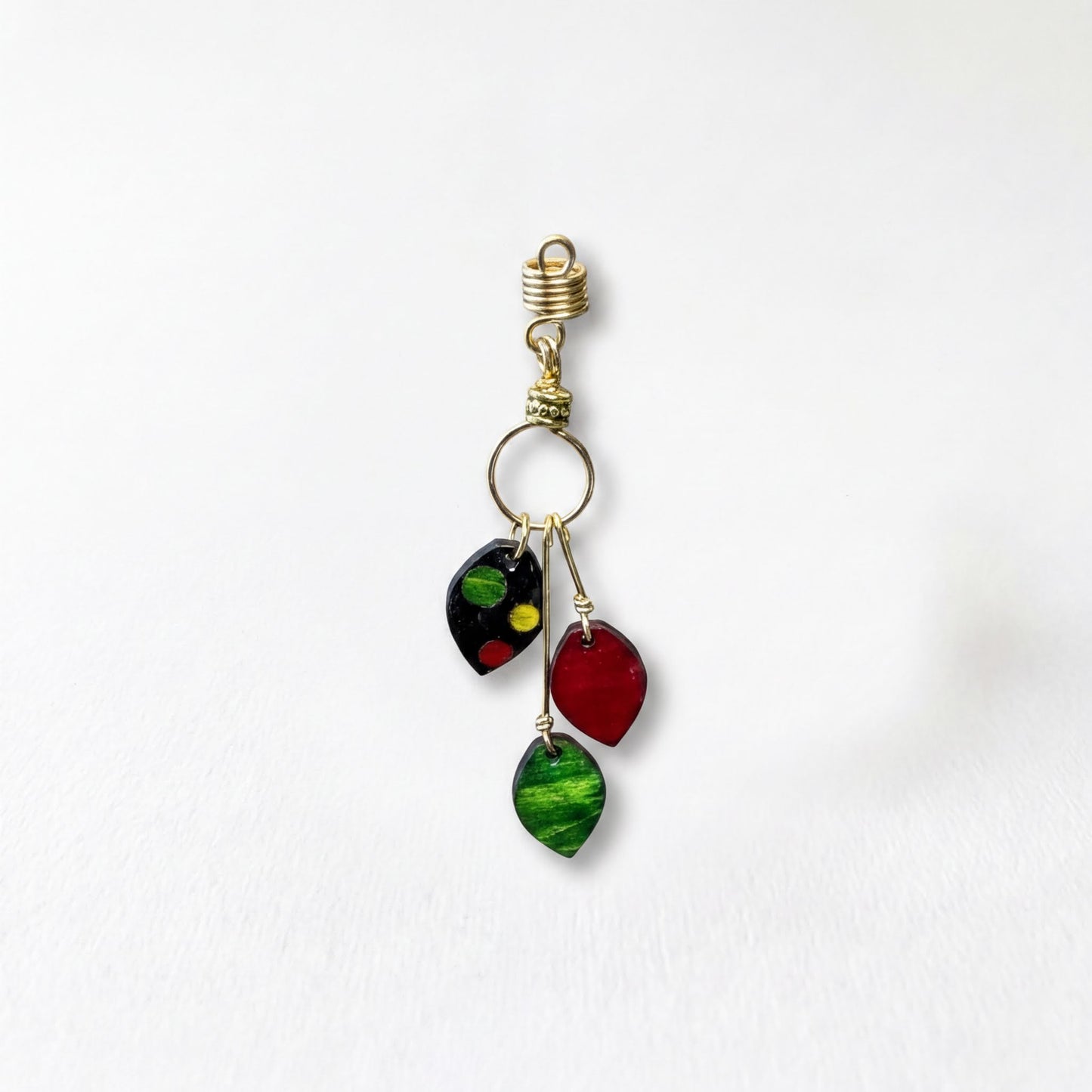 A decorative earring with a gold hook and three colorful leaf-shaped charms hanging from it.