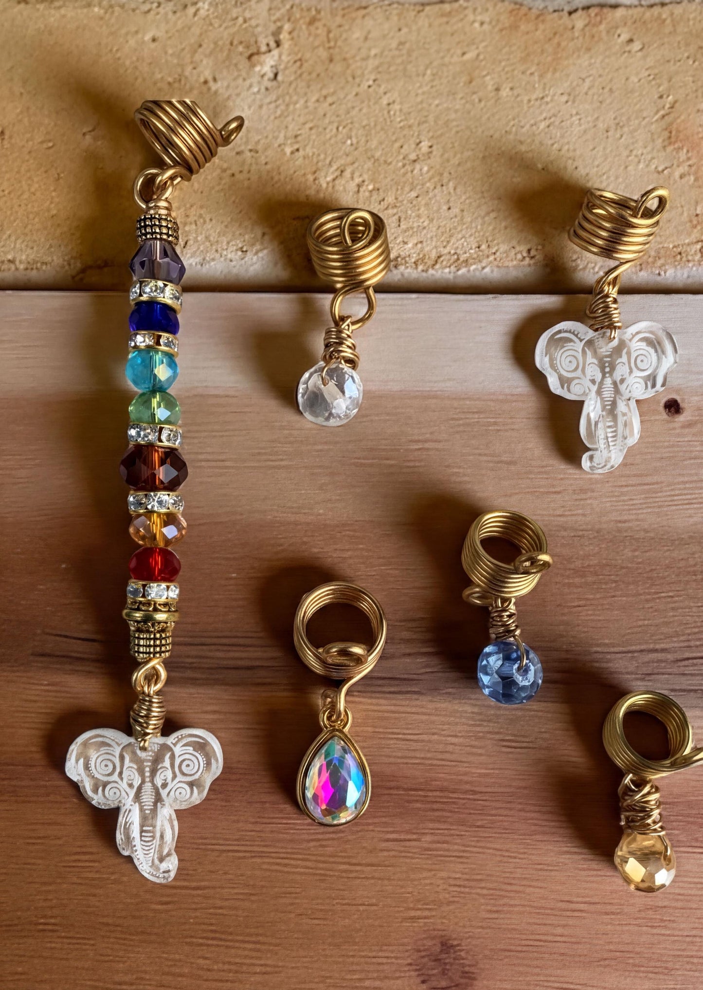 a collection of various jewelry pieces, including earrings and headbands, arranged on a wooden surface.