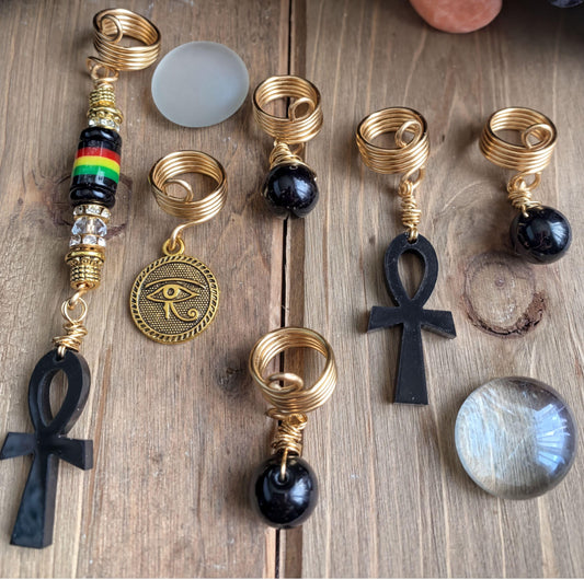 a collection of various jewelry pieces, including earrings and headbands, arranged on a wooden surface.