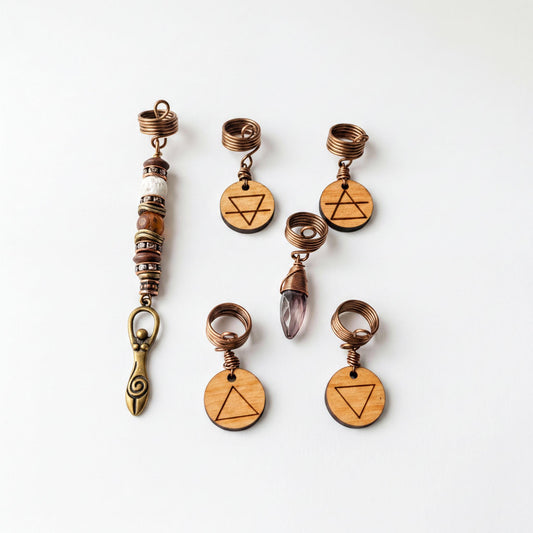 a collection of six wooden charms and five metal pendants, each with a unique design and symbol.