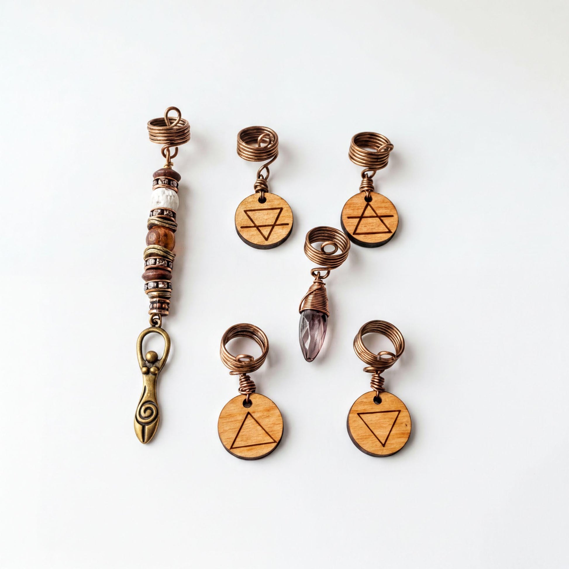 a collection of six wooden charms and five metal pendants, each with a unique design and symbol.