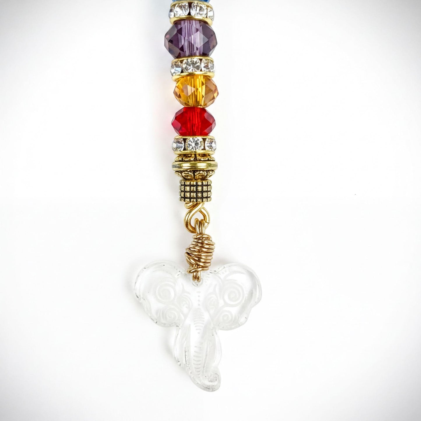 A clear glass pendant with a metal loop and a clear glass elephant-shaped charm, adorned with colorful beads and rhinestones.
