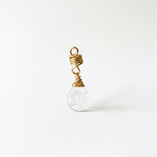 A clear glass pendant with a gold spiral design hanging from it.