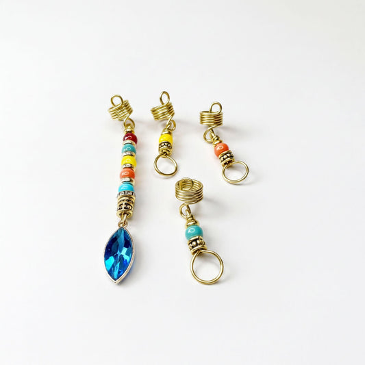 a collection of colorful, gold-colored hair accessories, including earrings and hair clips, arranged on a white background.