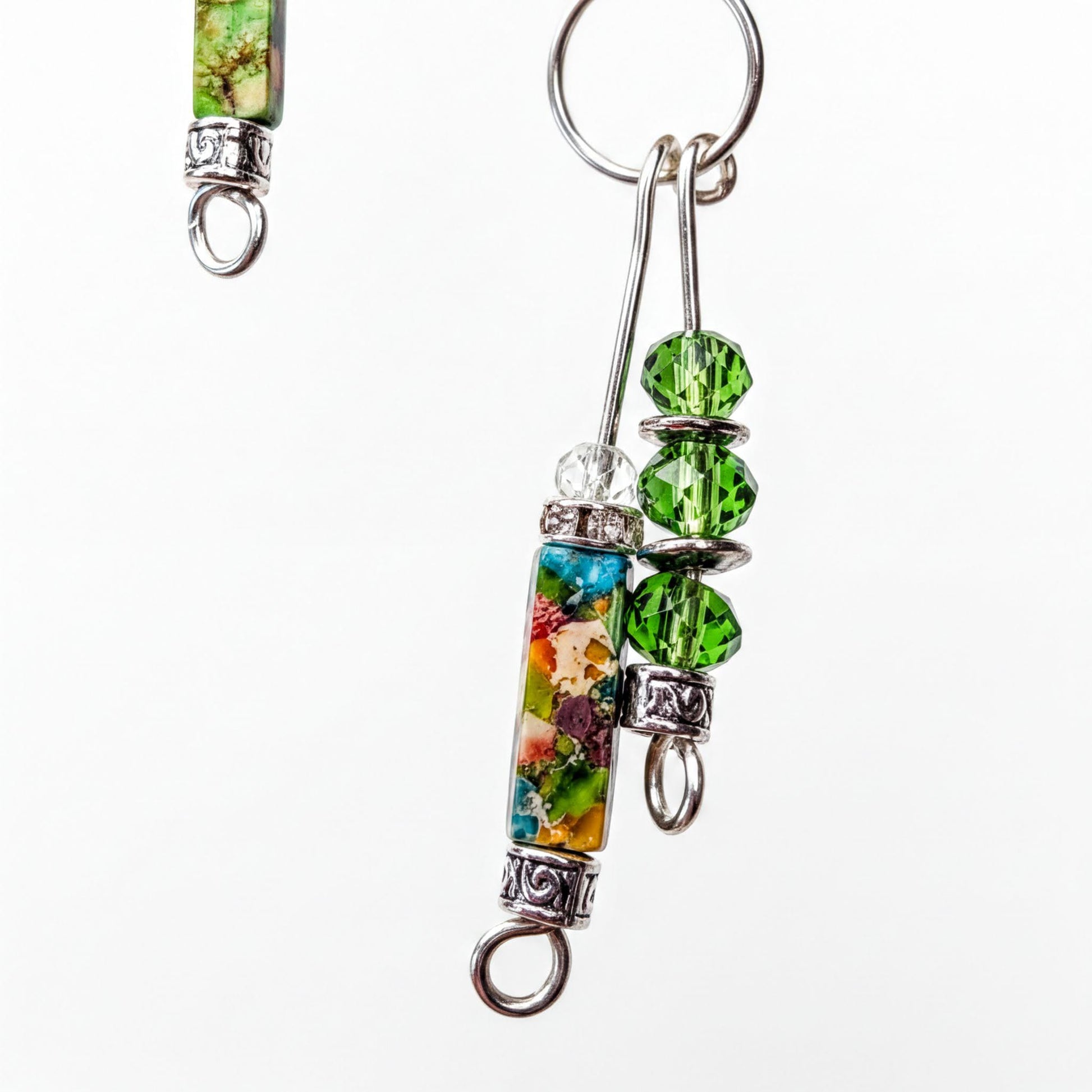 a close-up view of a colorful, multicolored bead necklace with a pendant and a charm.