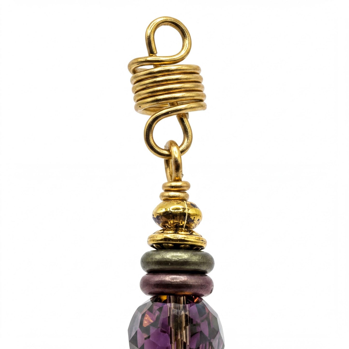 a close-up view of a decorative piece, possibly a necklace or earring, with a twisted metal component and a colorful bead at the top.