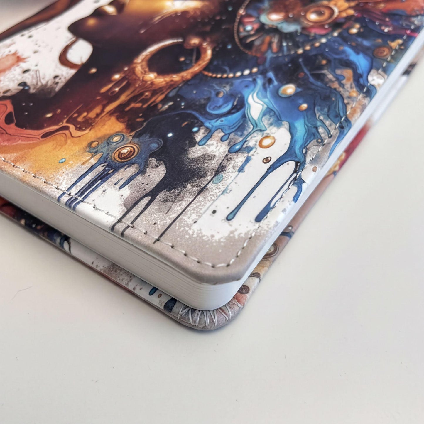 a colorful, artistic design on a notebook or book cover, with a mix of abstract and geometric patterns in various colors.
