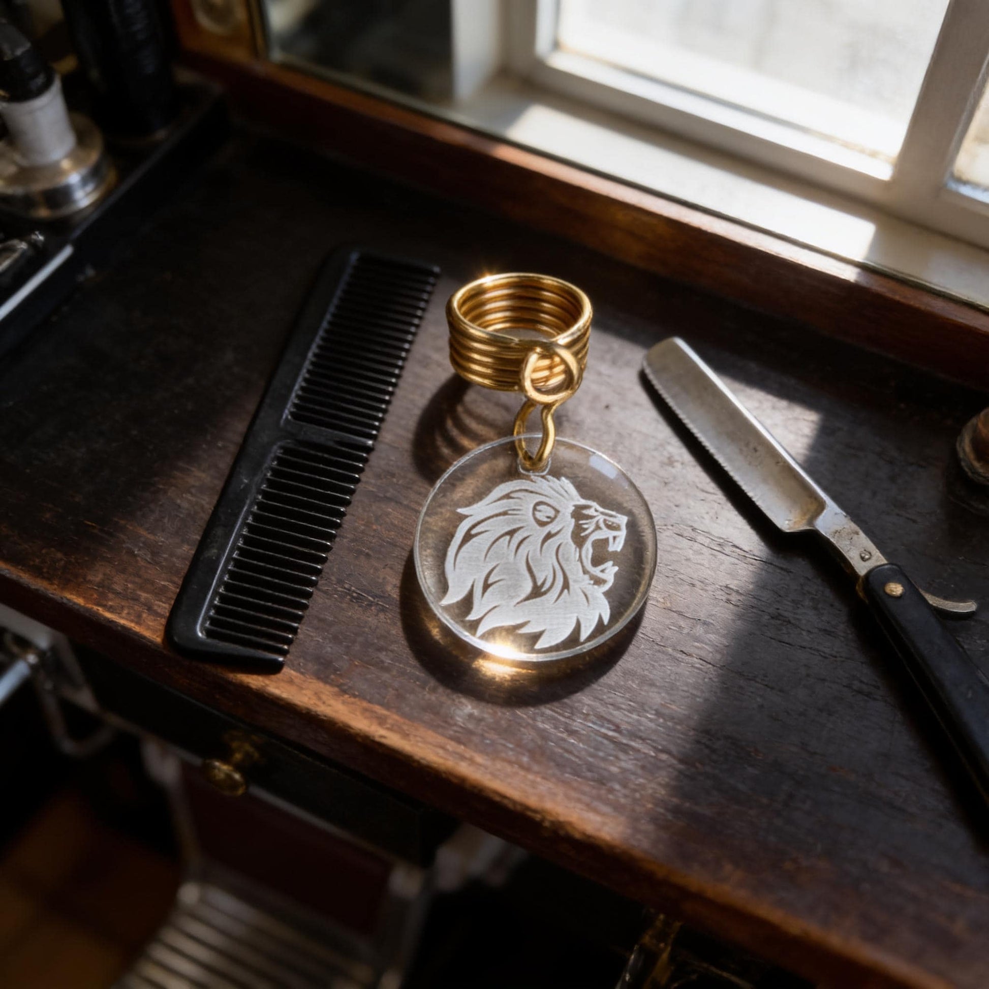 a collection of grooming tools, including a comb, a pair of scissors, and a keychain with a lion's head design.