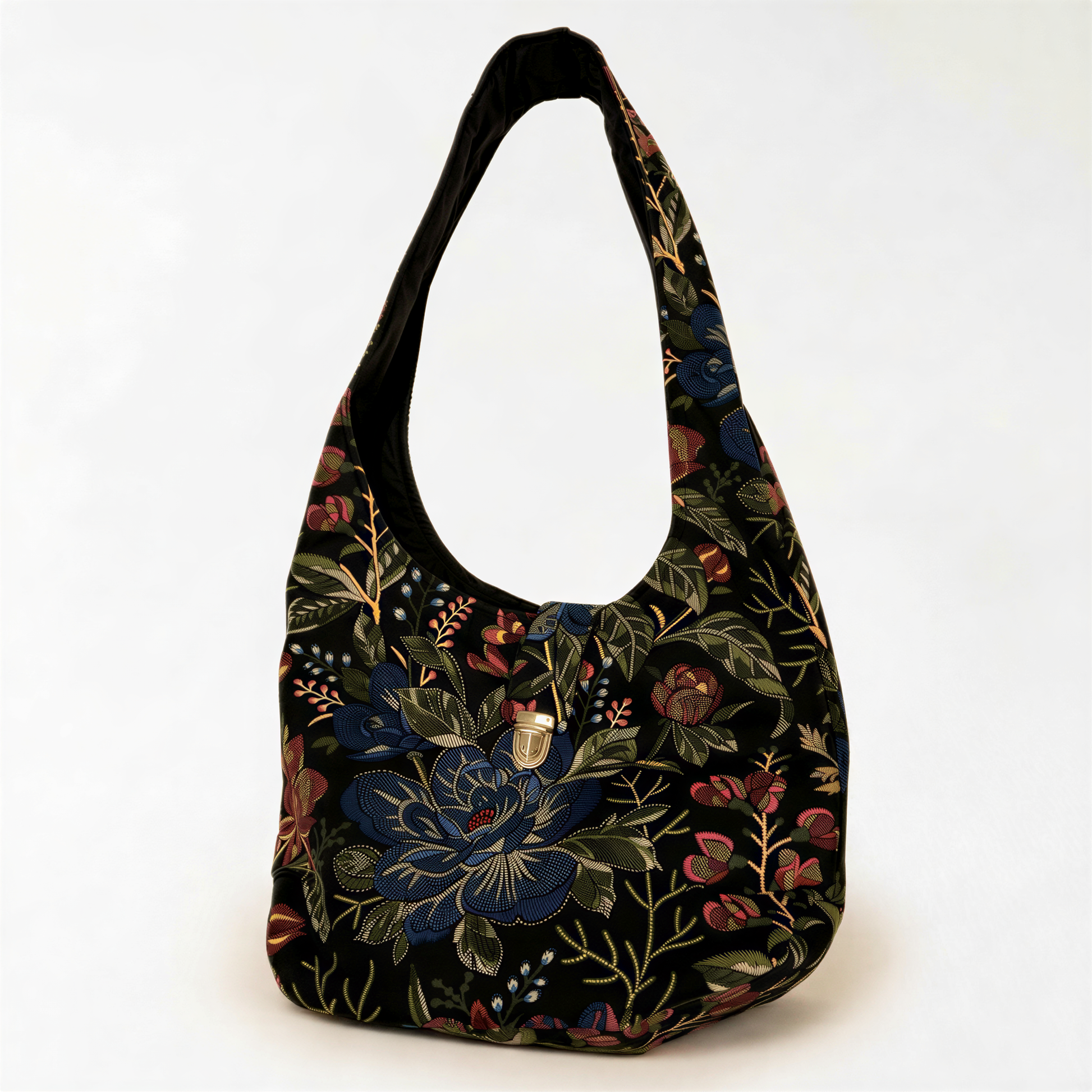 A black handbag with a floral pattern on the front, featuring a variety of colors including blue, green, red, and yellow.