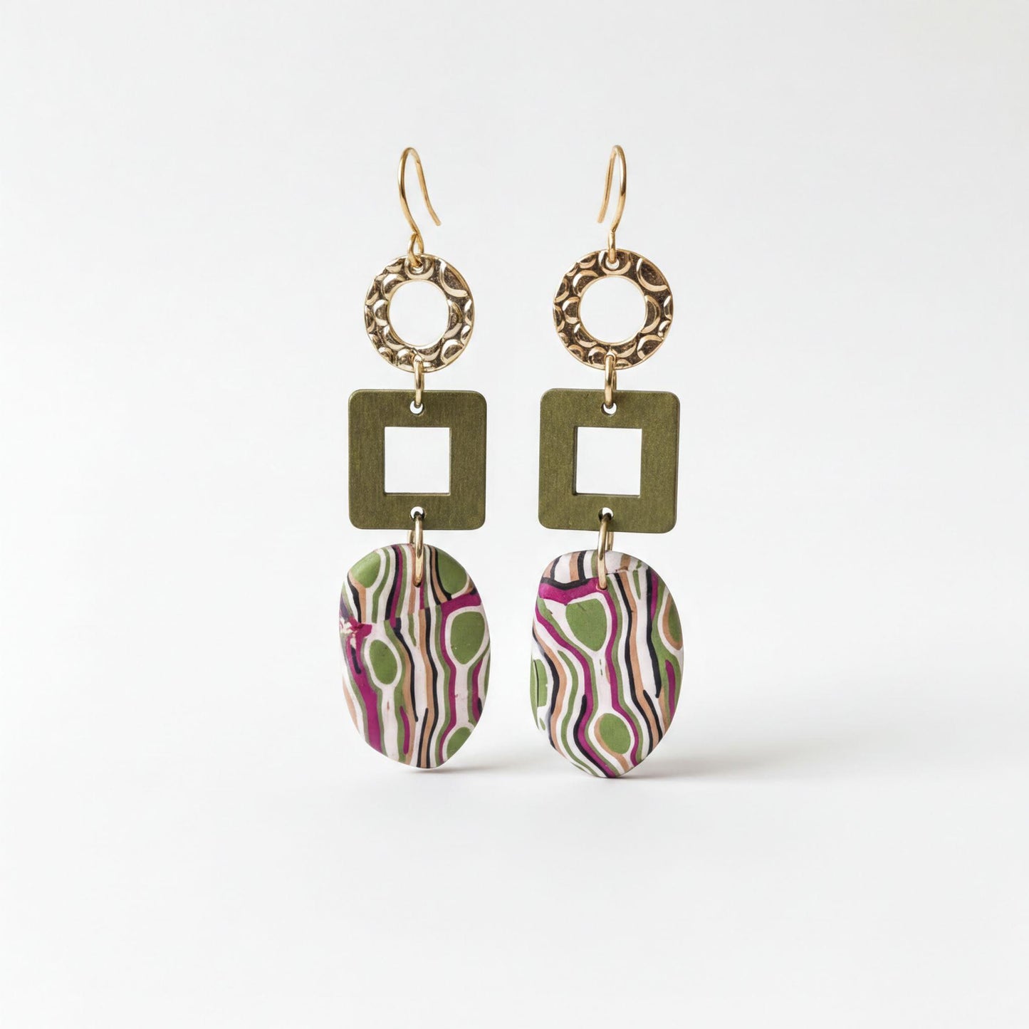 A pair of earrings with a unique design, featuring a combination of green, purple, and pink colors, as well as geometric shapes and patterns.
