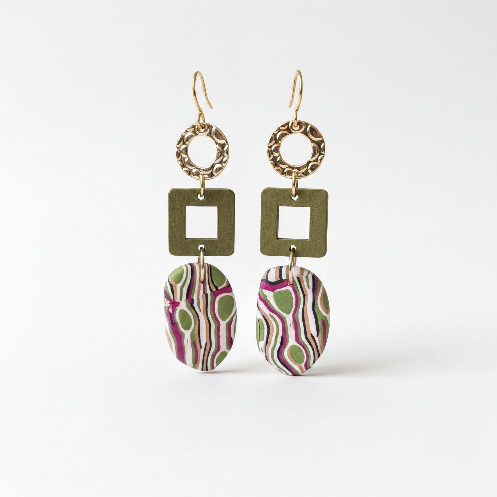 A pair of earrings with a unique design, featuring a combination of green, purple, and pink colors, as well as geometric shapes and patterns.