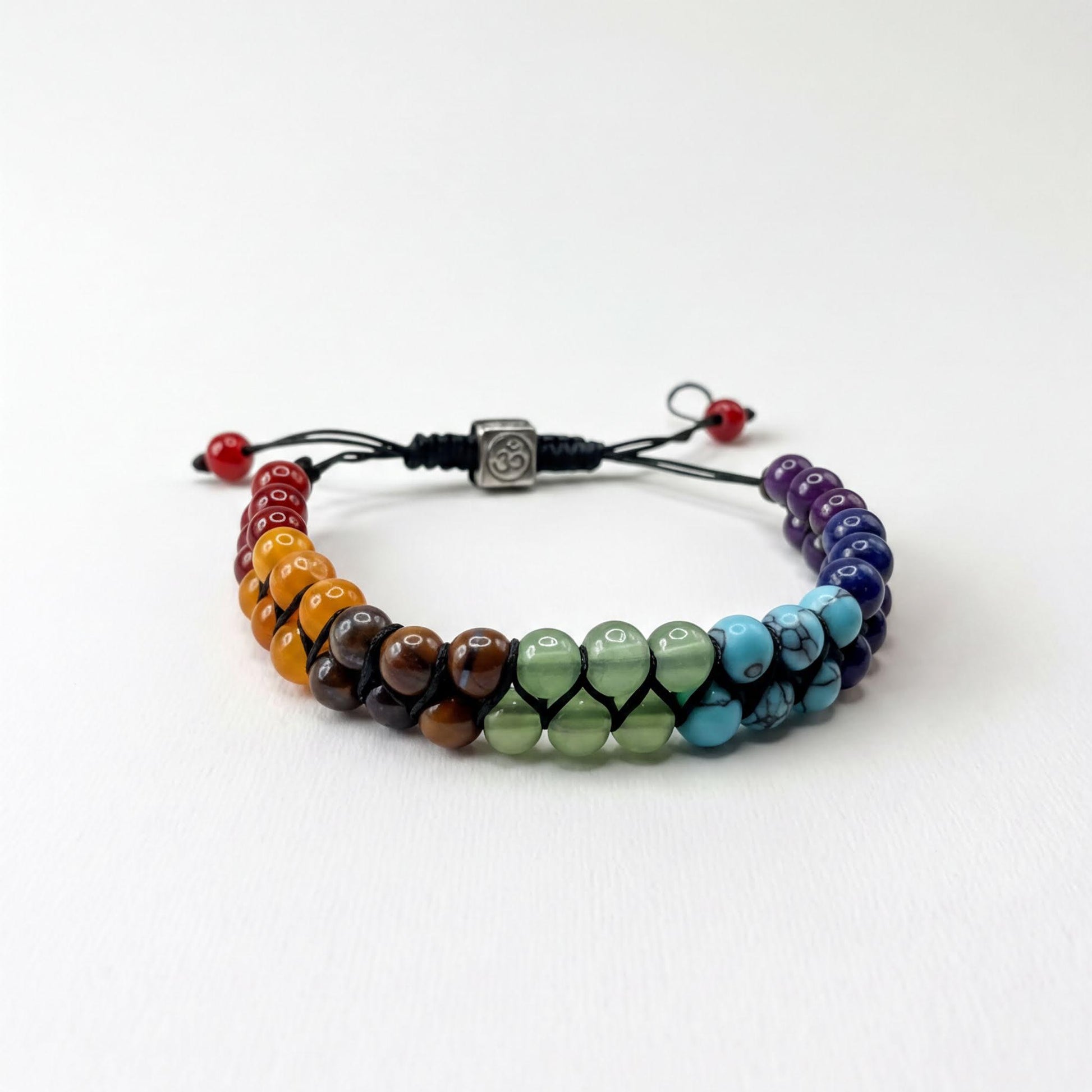 A colorful beaded bracelet with beads in various colors arranged in a rainbow pattern.