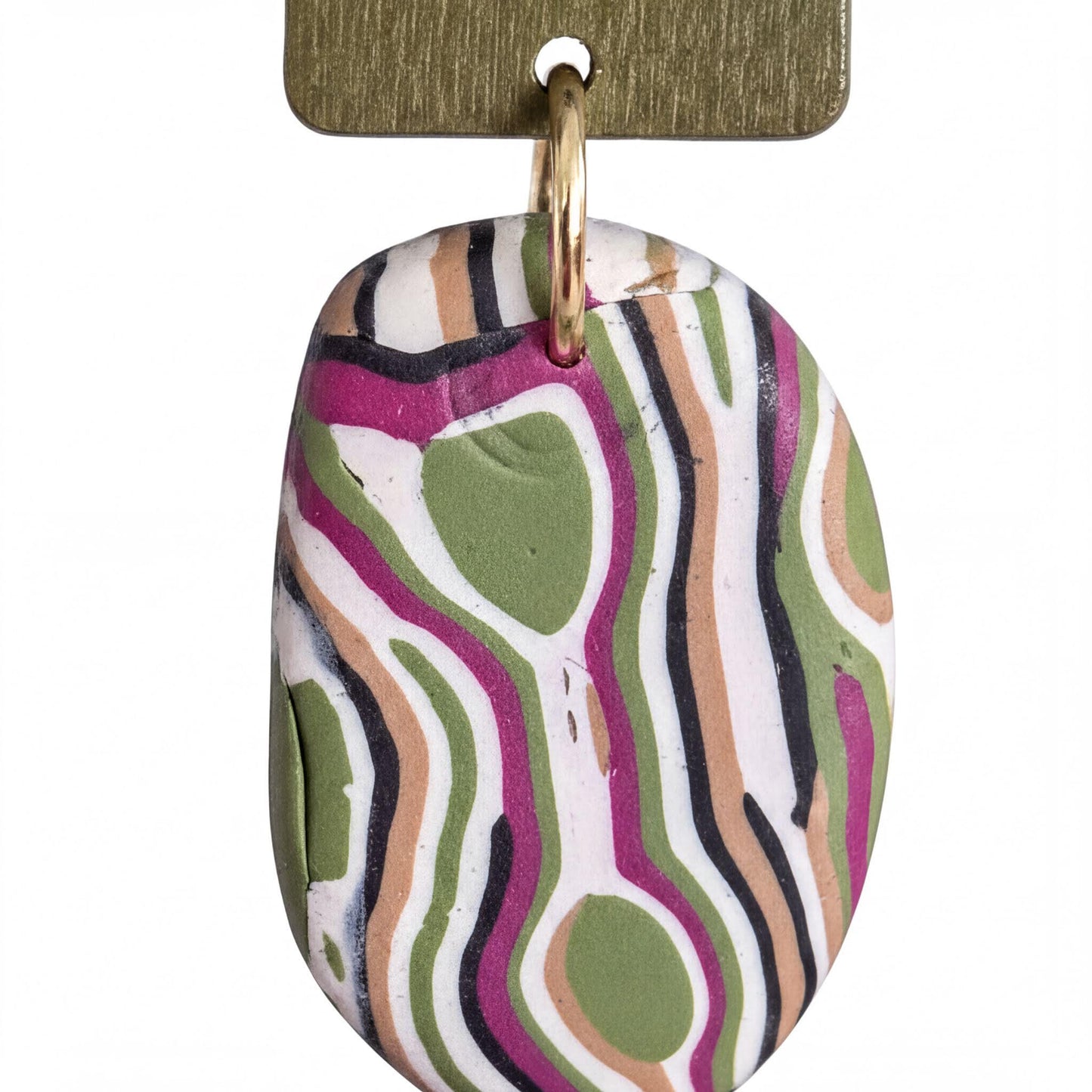 A colorful, abstract pendant made of a material that resembles clay or a similar organic shape, with a metallic hook attached to it.