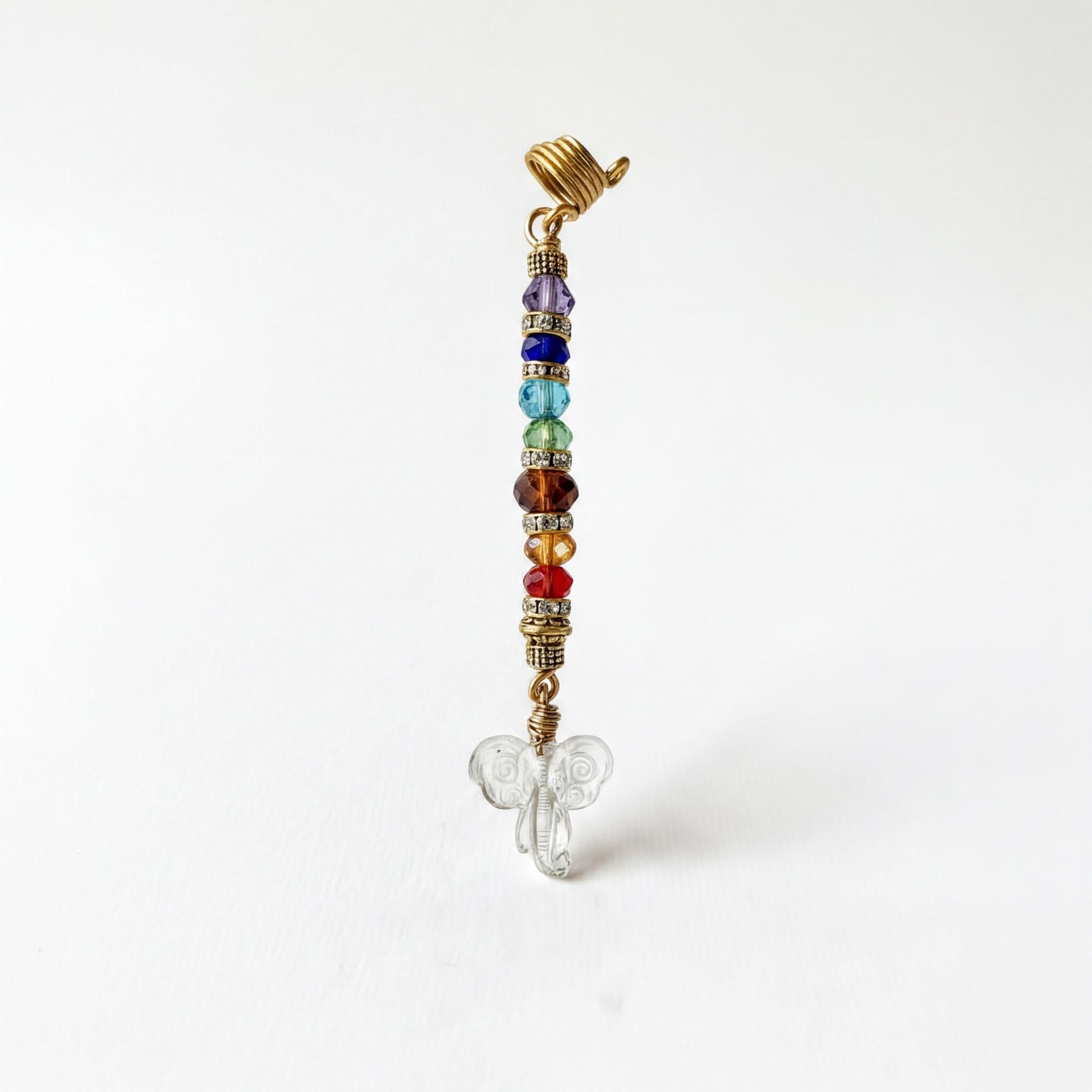 A colorful beaded charm with a butterfly design, featuring a gold-colored clasp and a clear glass butterfly at the bottom.