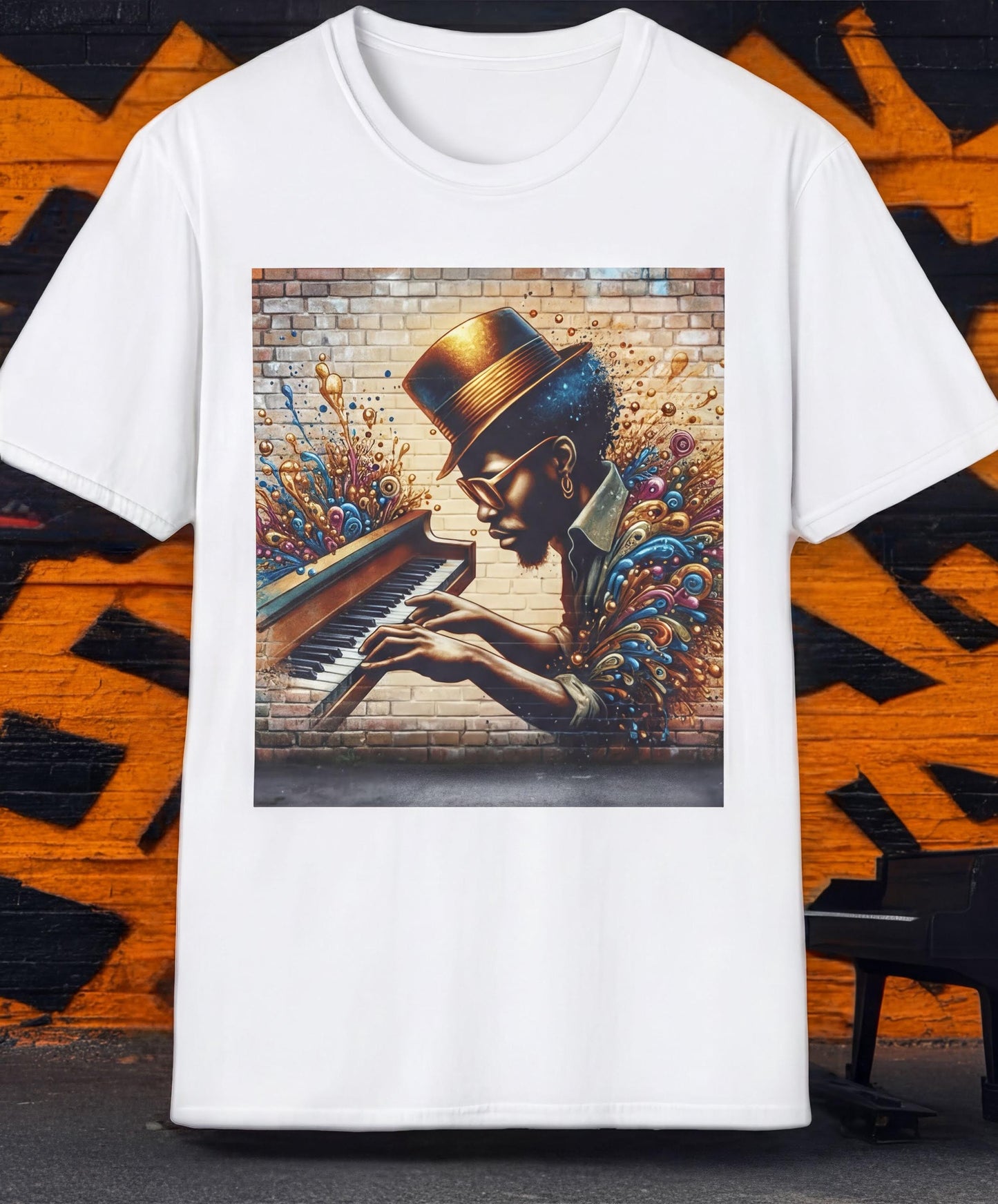 A white t-shirt with a colorful graphic design depicting a person playing a piano against a brick wall background.