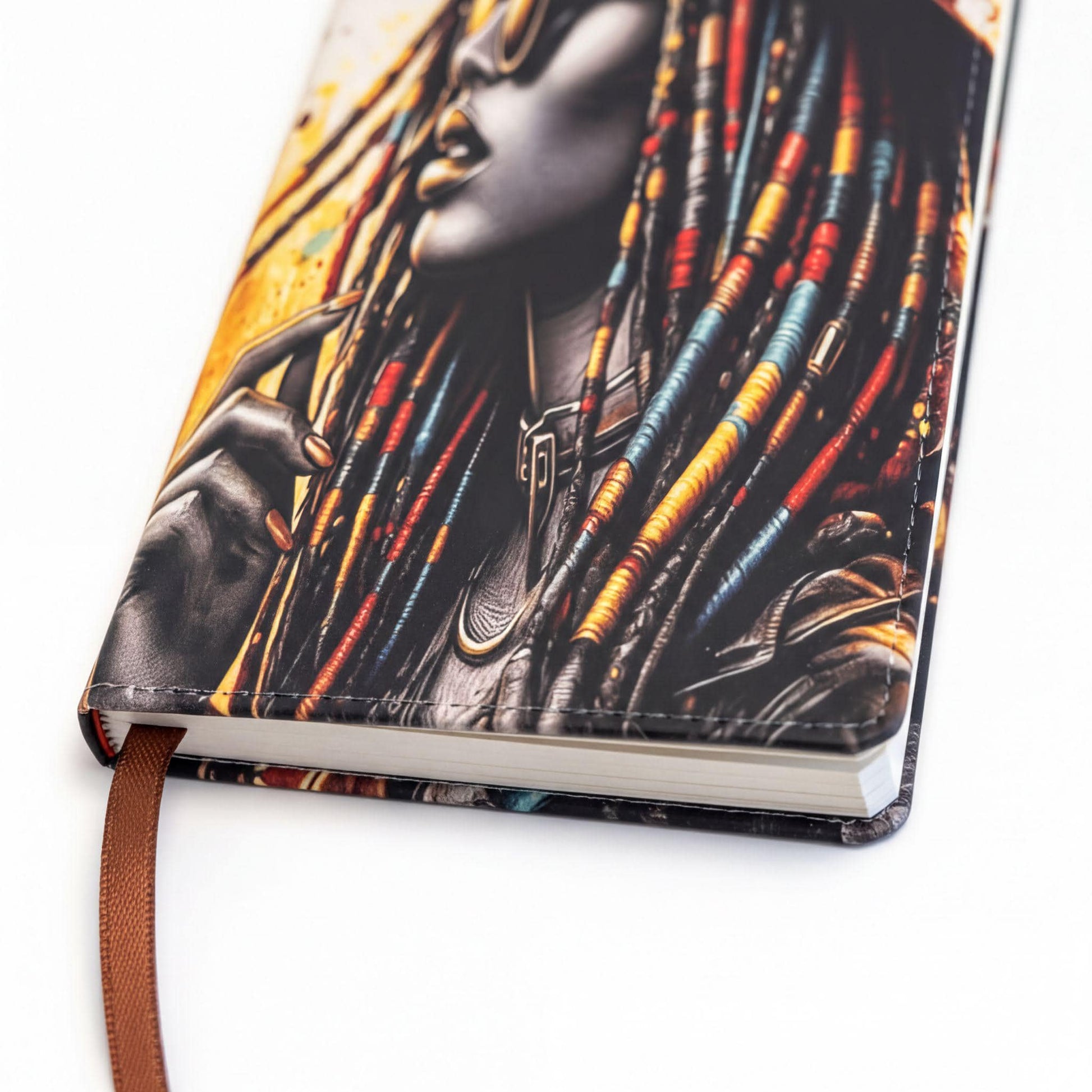 a notebook cover with a colorful, artistic portrait of a woman with dreadlocks.