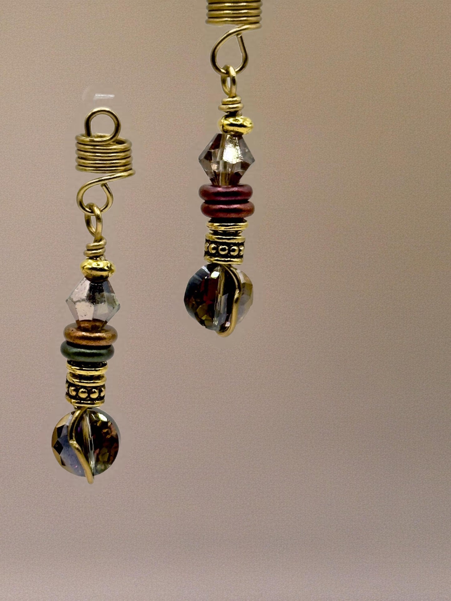 a pair of ornate earrings with a combination of colorful beads and metallic elements, such as gold and silver.