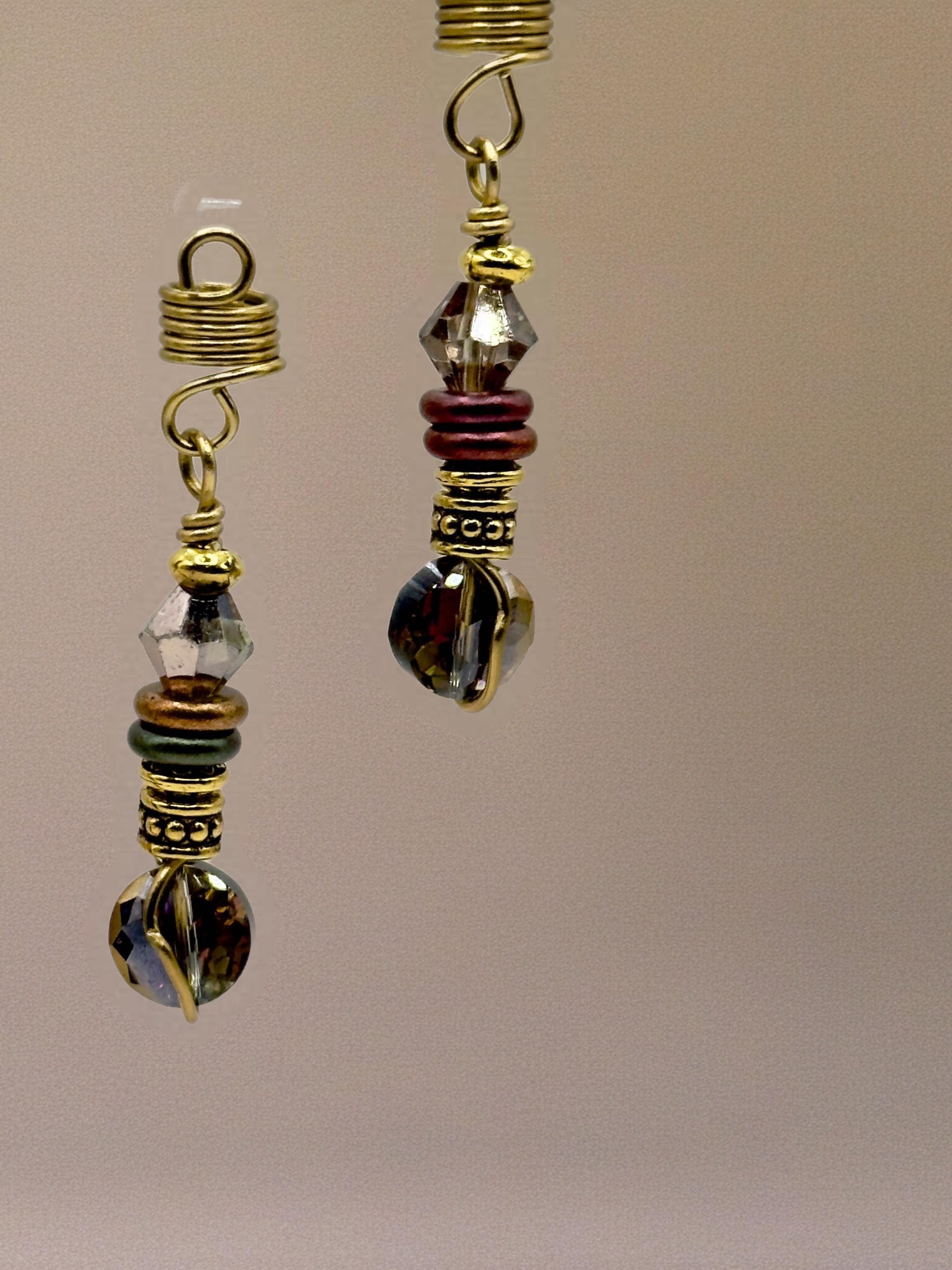 a pair of ornate earrings with a combination of colorful beads and metallic elements, such as gold and silver.