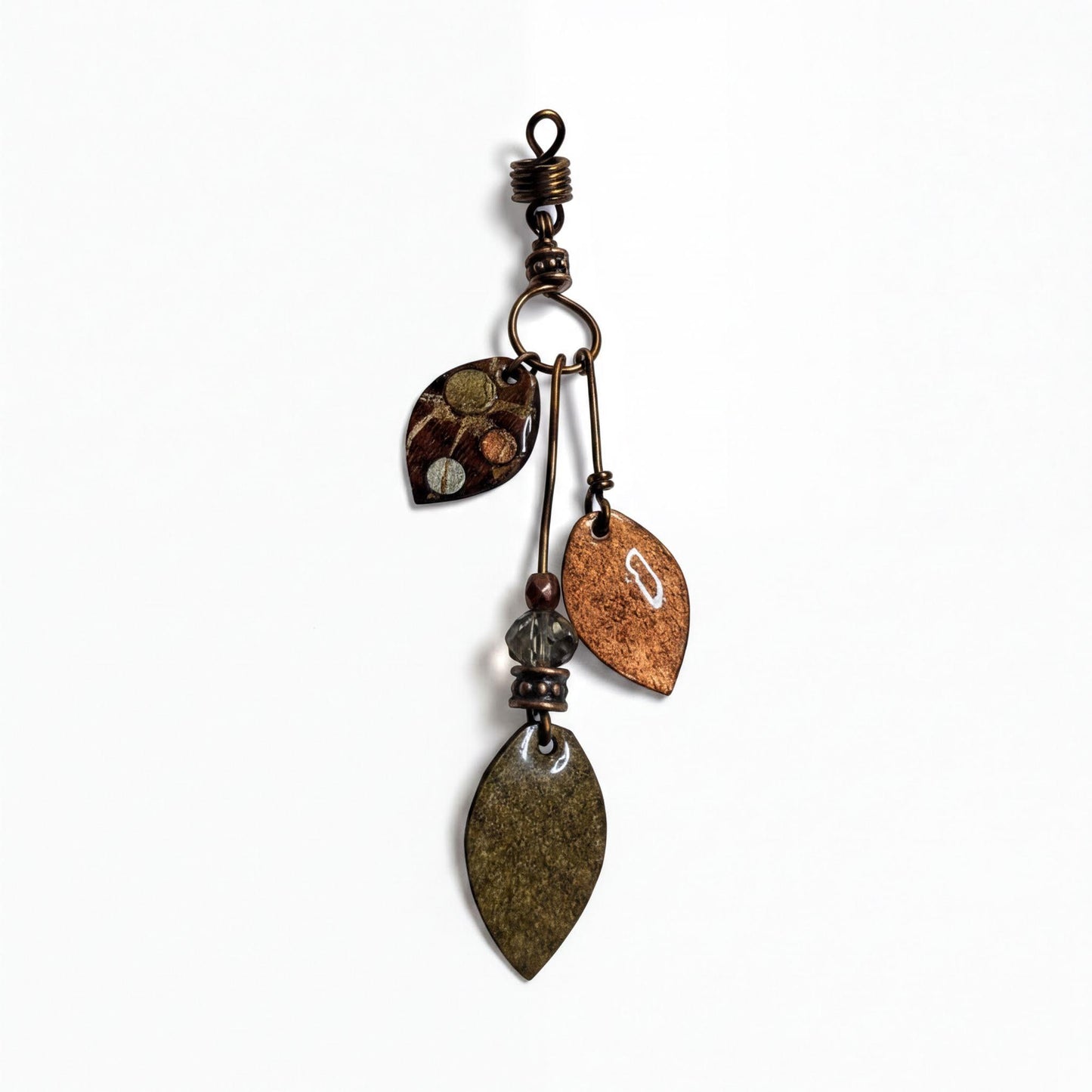 A decorative metal pendant with various leaf-shaped charms and a metallic hook at the top.