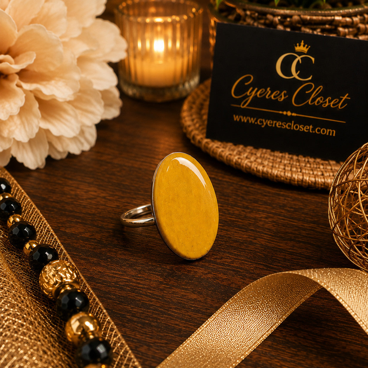 Cyere's Closet mustard yellow oval basswood statement ring with a glossy finish on a dark wooden surface.