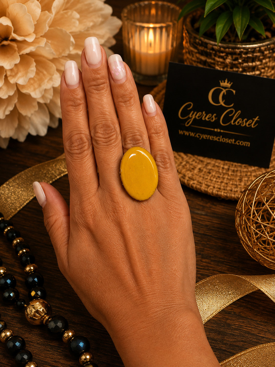 Cyere's Closet Golden Sol mustard yellow hand-painted basswood oval statement ring worn on a hand