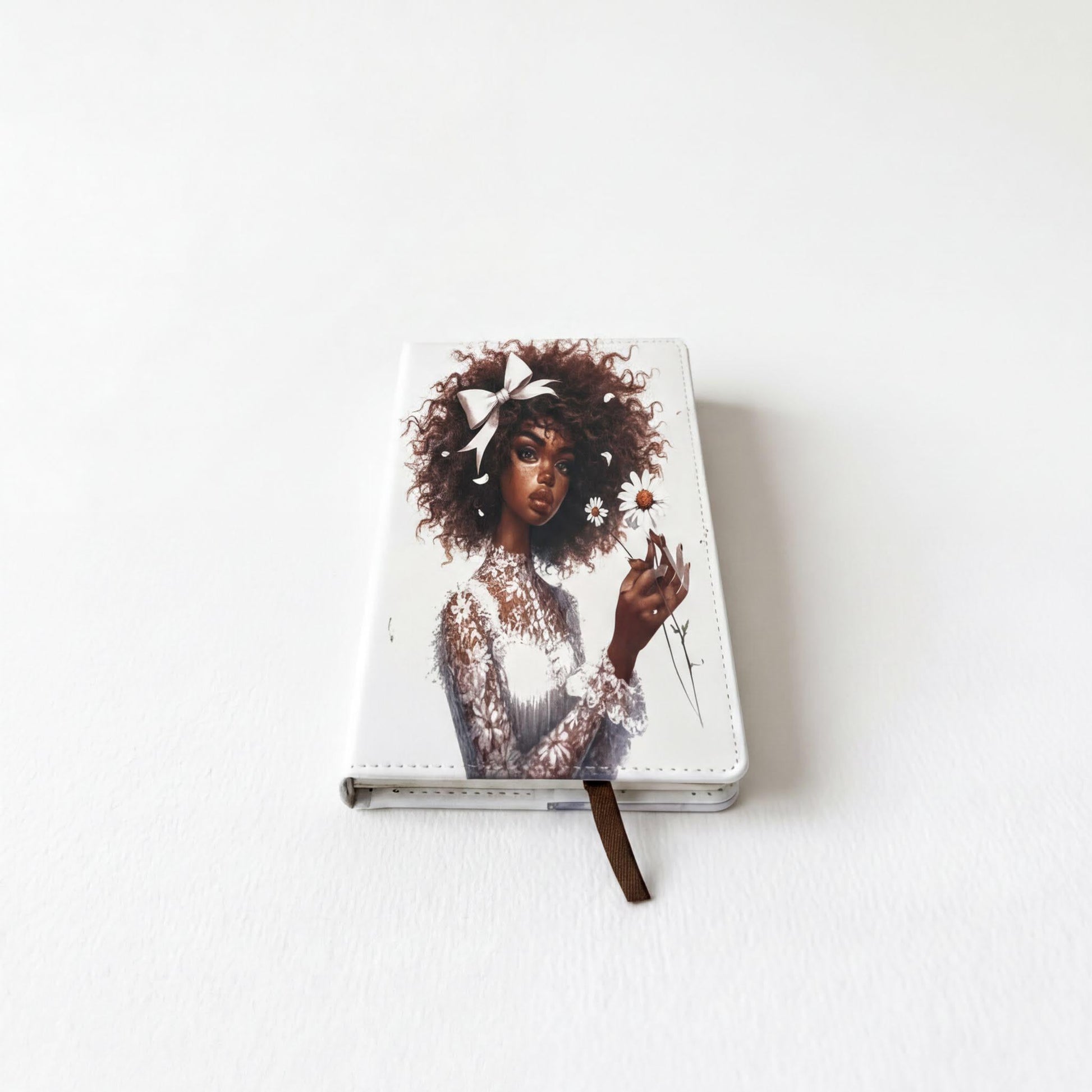 a notebook cover with a portrait of a woman with curly hair and a white dress.
