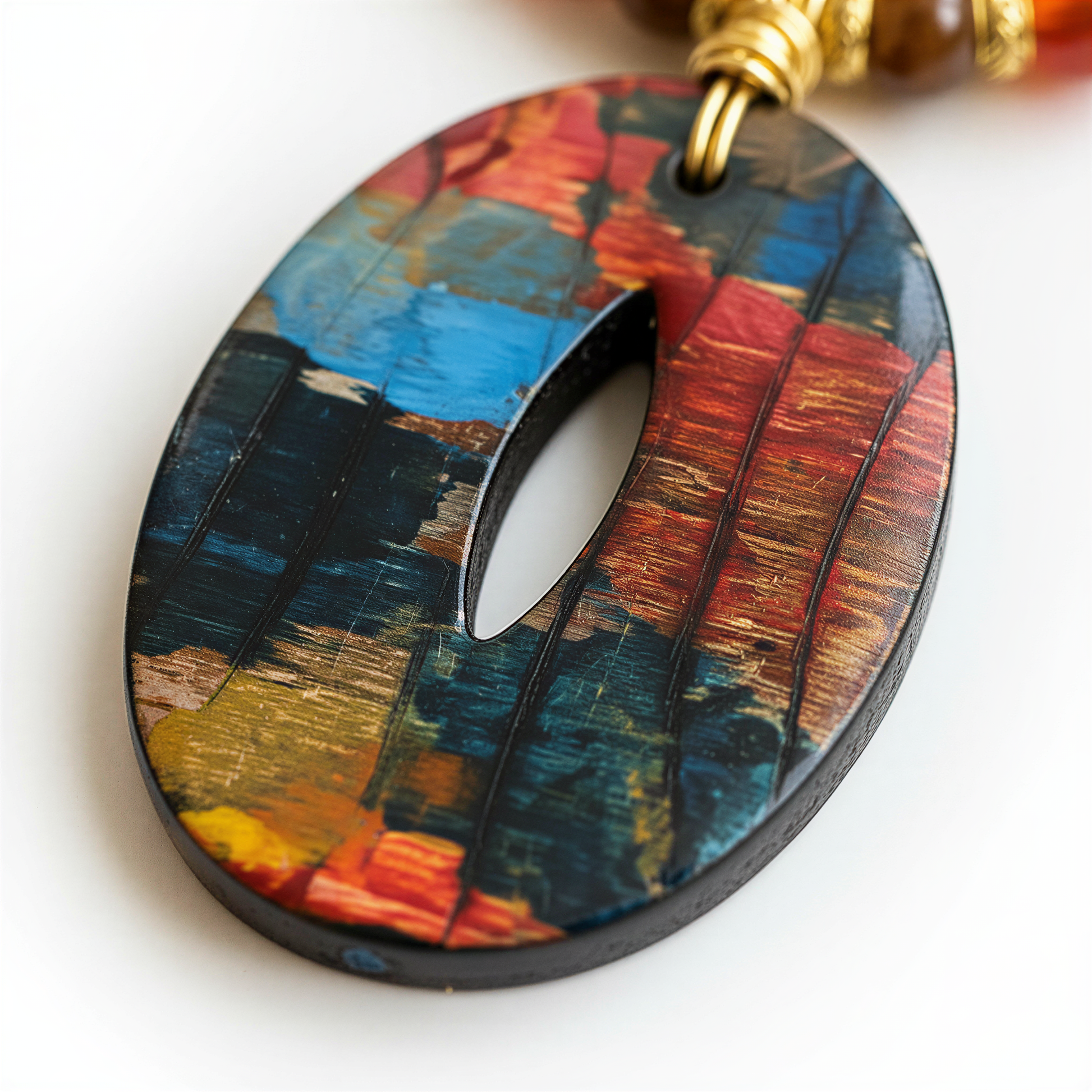 A colorful pendant with a unique, abstract design is shown in the image.