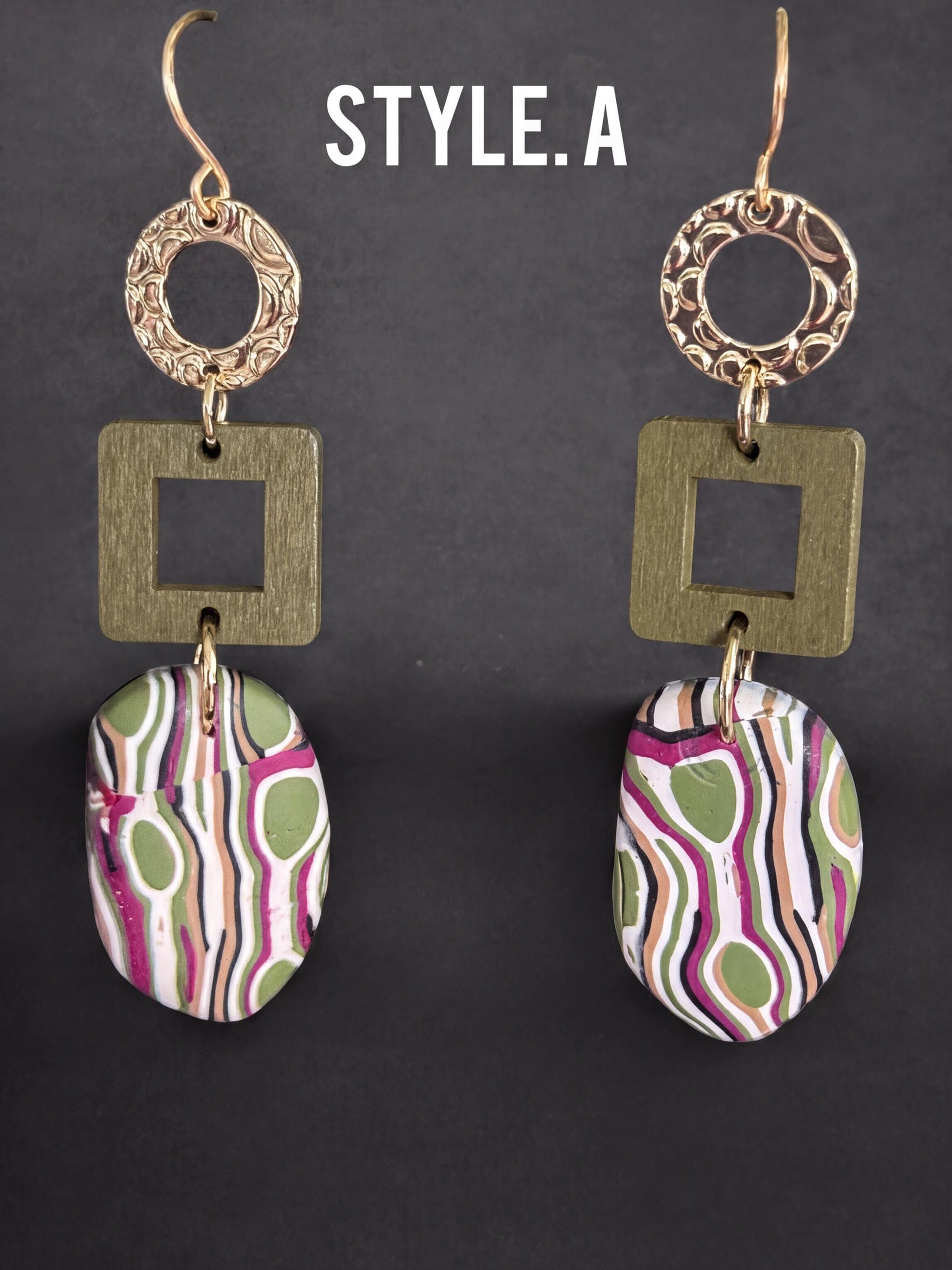 A pair of earrings with a unique design, featuring a combination of geometric shapes and abstract patterns in various colors.